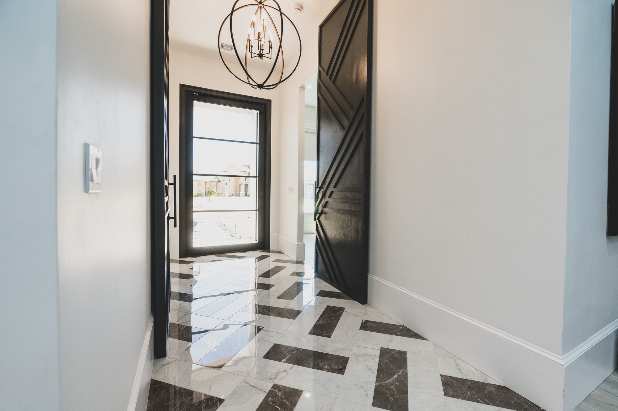 Entry with herringbone marble floor at 105 Lac Lafreniere Court
