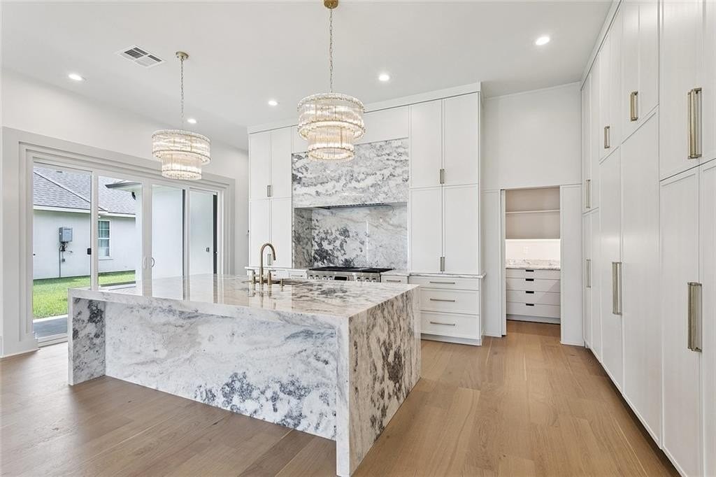 Custom kitchen with waterfall island in a River Parish Construction home